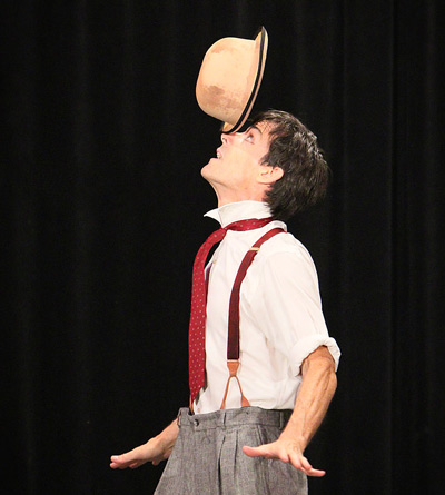 Peter Davison balances a derby hat on his nose, one of many skillful feats in LocoMotion: The Science & Circus Arts Show.